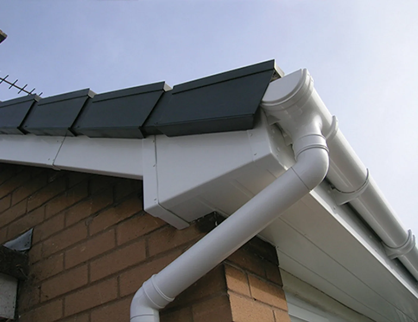 Roof gutter system installed on a brick building